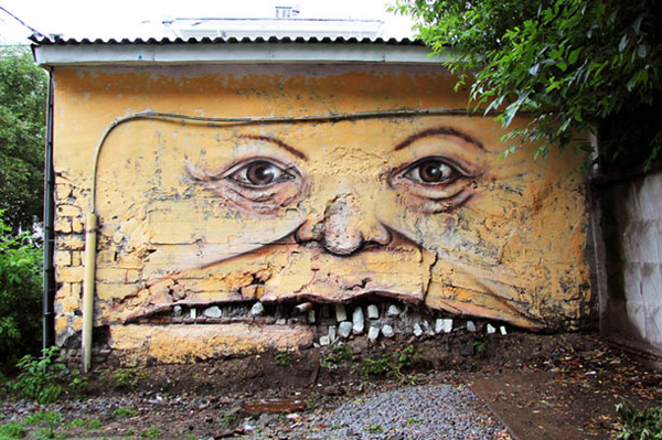 Russian Street Artist Makes Faces Out Of Old Buildings Russian Street Artist Makes Faces Out Of Old Buildings