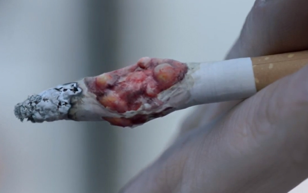 Graphic Stop Smoking Ad Shows Cancerous Tumour Growing on Cigarette smoking kills advertisement Graphic Stop Smoking Ad Shows Cancerous Tumour Growing on Cigarette