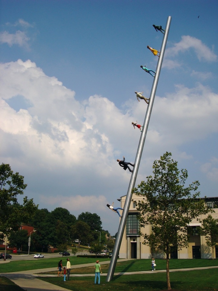 Gravity Defying Sculpture of People Walking Up a Pole