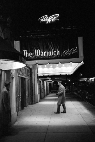 01 March 17 1956. The Warwick New York. A cold winters day in March. Here Elvis is walking into his hotel alone Photographs of Elvis Presley in the Beginning by Alfred Wertheimer