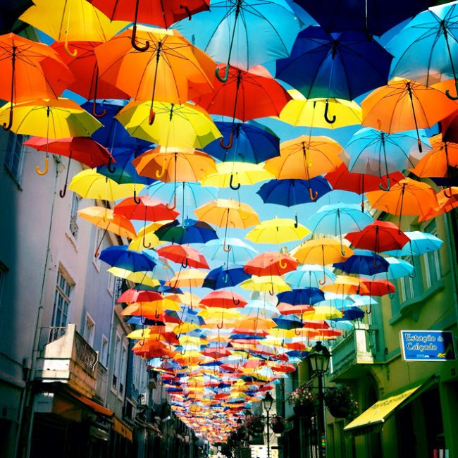 http://designyoutrust.com/wp-content/uploads/2013/07/1-new-floating-colorful-umbrellas-in-agueda-by-ivo-tavares-studio-650x650.jpg