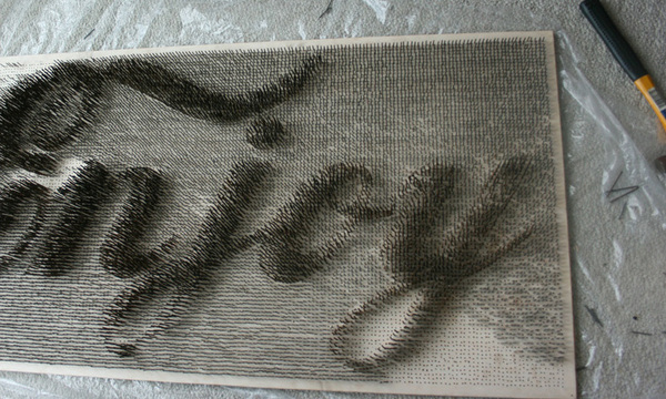  18,000 nails spelling the word “enjoy”