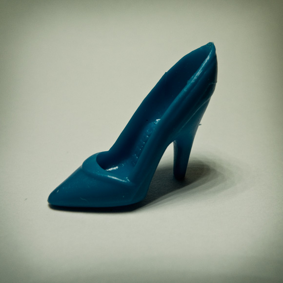 blue Photographs of tiny plastic shoes for dolls