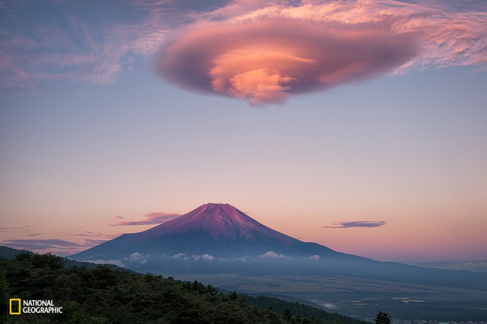 Mount Fuji creates two types of lenticular clouds. One is called Kasagumo (umbrella cloud) and appears on top of Fuji. The other is called Tsurushigumo and shows up in the lee. Fuji created a huge Tsurushigumo this morning and it became pink just before the sunrise.