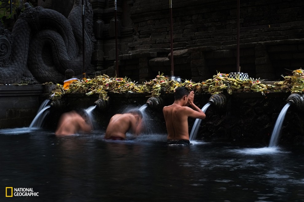 Bathing ritual taken place in one of the main temple in Bali, Tirta Empul Temple. Its fresh spring water is believed as holy water to purify the body and soul.
