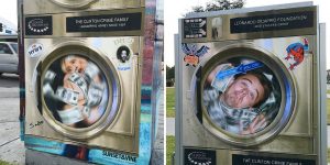 Street Art Puts Leonardo DiCaprio And Hillary Clinton In Money-Laundering Machine