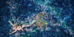 Powerful Photos Show Mermaids Swimming In A Plastic Bottle Ocean