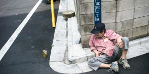 Shocking Photographs Show Japanese Drinkers Using Pavements, Doorways And A Plant Pot As Impromptu Pillows After Succumbing To The Effects Of Alcohol