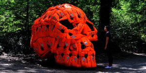 Pedro Pires Sculpts Large-Scale Skull Using 140 Life Vests And Rubber From A Refugee Dinghy