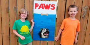 These Guys Make Neighborhood Laugh with Creative Fence Windows for Dogs