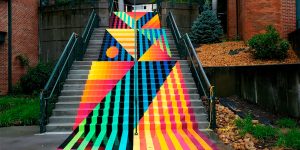 Artist Duo Brings Life Into A Boring Old Stairway By Painting A Bright And Colorful Rug-Shaped Mural